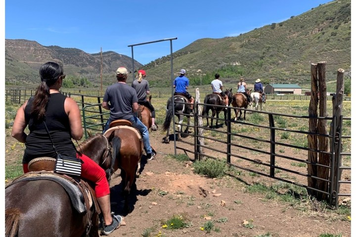 a group of people riding on the back of a horse